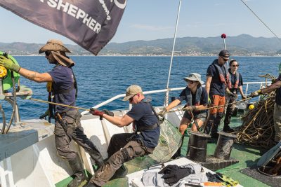 intense pulling of rope, with a fish traps attached